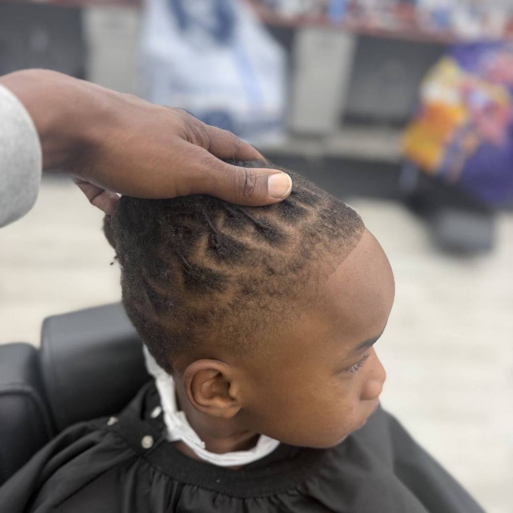 Child's locs with a clean part and taper
