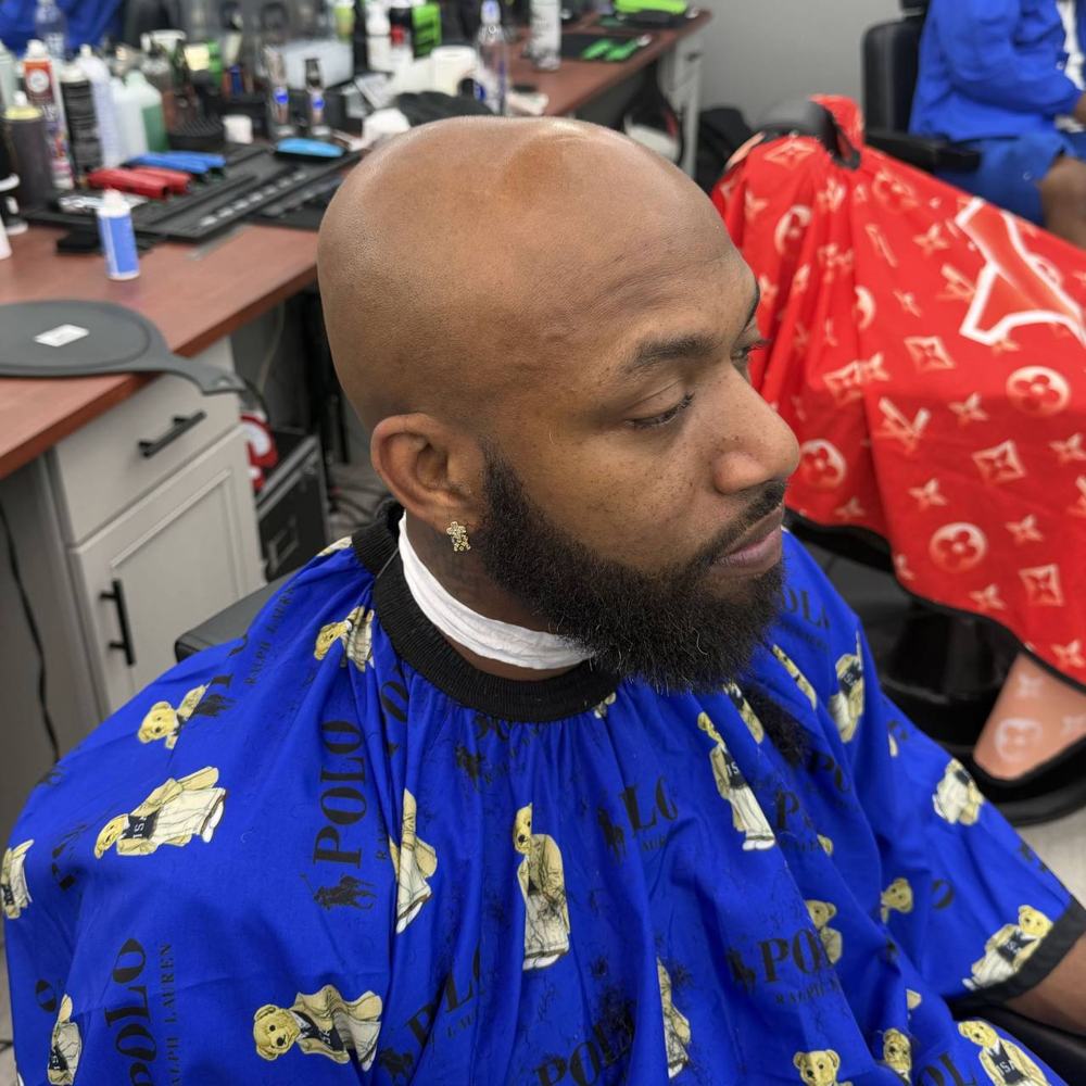 Clean bald head shave with a full beard
